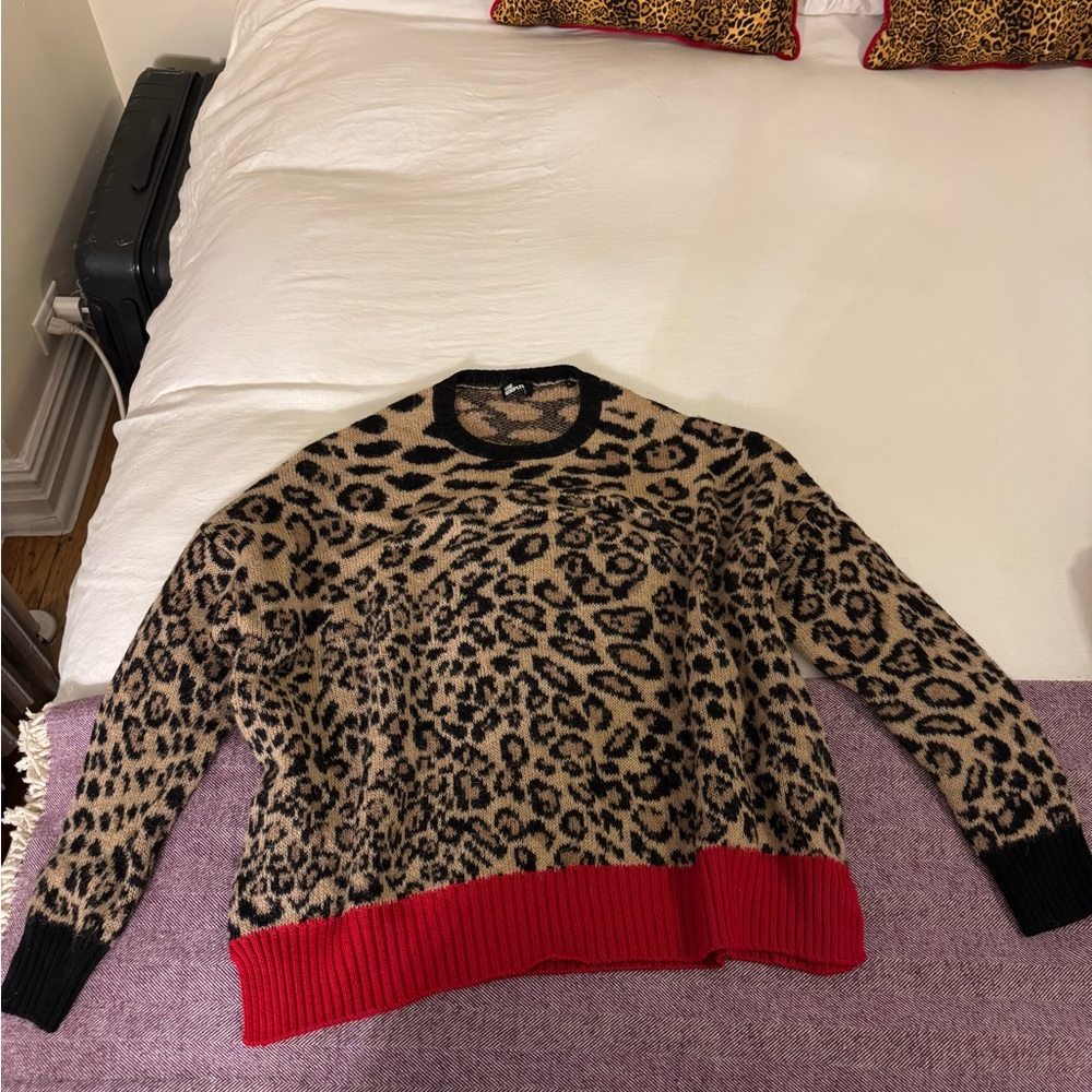 The kooples cheetah sweater with red and black accents.